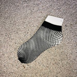 Unused pair of fishnet socks. About crew length.